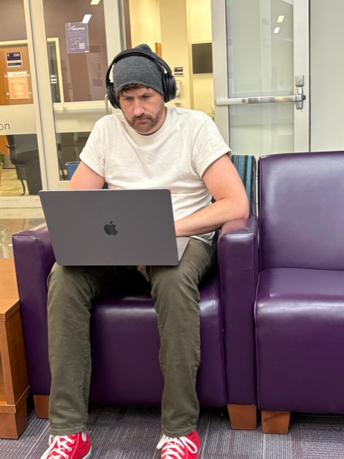 Justin working on a laptop